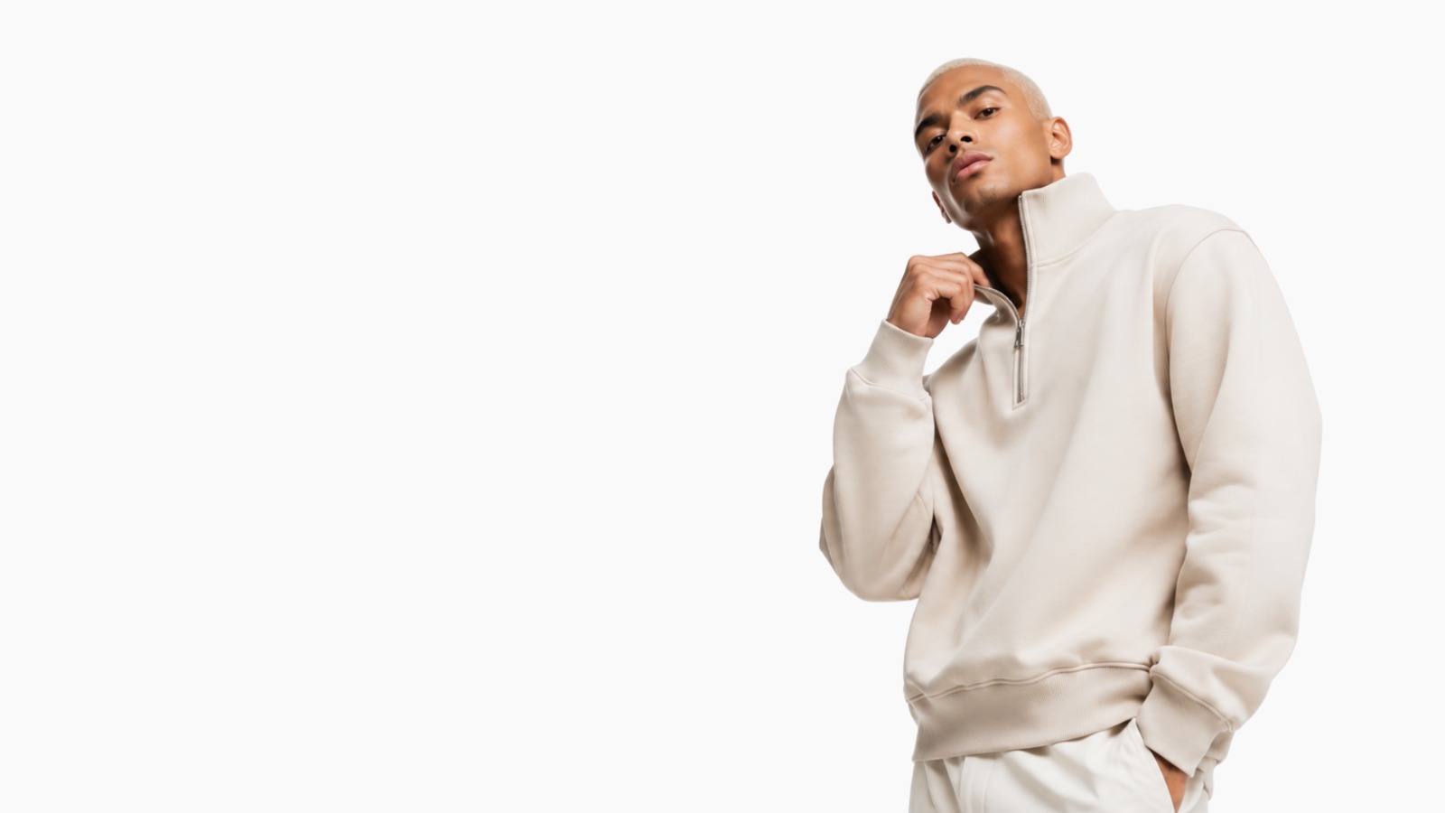 Model wearing a cream half-zip sweatshirt manufactured by Safir Wear